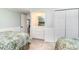 Comfortable bedroom features twin beds, closet space and built in vanity with mirror at 668 S Waccamaw Dr., Murrells Inlet, SC 29576