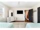 Spacious bedroom featuring hardwood floors, flat screen tv and white dresser with mirror at 668 S Waccamaw Dr., Murrells Inlet, SC 29576