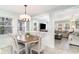 Inviting dining area features a wooden table, white chairs, and access to the living room at 668 S Waccamaw Dr., Murrells Inlet, SC 29576