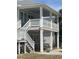 Beautifully elevated beach home with staircase entry and a covered patio for outdoor enjoyment at 668 S Waccamaw Dr., Murrells Inlet, SC 29576
