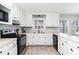 Bright, all-white kitchen equipped with modern appliances and ample cabinet space at 668 S Waccamaw Dr., Murrells Inlet, SC 29576
