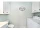 Functional laundry area with a washer, dryer, and ample cabinet storage at 668 S Waccamaw Dr., Murrells Inlet, SC 29576