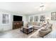 Cozy living room featuring a large sofa, a tv and multiple windows allowing lots of natural light at 668 S Waccamaw Dr., Murrells Inlet, SC 29576