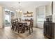 Dining room with wood table, chandelier, and sliding glass door to patio at 700 Lorenzo Dr., North Myrtle Beach, SC 29582