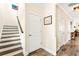 The home's entryway has hardwood floors, a staircase with dark treads, and a coat closet at 700 Lorenzo Dr., North Myrtle Beach, SC 29582