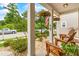 Relaxing front porch featuring rocking chairs, hanging flower baskets, and an American flag at 700 Lorenzo Dr., North Myrtle Beach, SC 29582