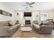 Comfortable living room with a fireplace, neutral-toned sofas, a ceiling fan, and a woven rug at 700 Lorenzo Dr., North Myrtle Beach, SC 29582