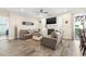 Spacious living room featuring fireplace, ceiling fan, wood-look tile, and patio access at 700 Lorenzo Dr., North Myrtle Beach, SC 29582