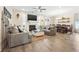 Spacious living room features a fireplace, ceiling fan, and an adjacent dining area with an inviting open-concept layout at 700 Lorenzo Dr., North Myrtle Beach, SC 29582