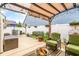 Cozy outdoor patio featuring a pergola, comfortable seating, and charming garden decor and firepit at 700 Lorenzo Dr., North Myrtle Beach, SC 29582