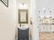 Stylish powder room with decorative mirror, stylish vanity, and views to the kitchen at 700 Lorenzo Dr., North Myrtle Beach, SC 29582