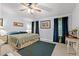 Cozy bedroom with ceiling fan, carpet, and green and blue curtains accenting natural light at 7012 Walden Ct., Myrtle Beach, SC 29588