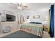 Bright bedroom featuring neutral carpet, ceiling fan, natural light, and a connecting ensuite bathroom at 7012 Walden Ct., Myrtle Beach, SC 29588