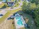 Aerial shot of the community pool with many lounge chairs and a bath house surrounded by lush trees at 7012 Walden Ct., Myrtle Beach, SC 29588