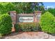 Welcoming brick entrance sign for Amberfield, surrounded by lush greenery and featuring a pineapple detail at 7012 Walden Ct., Myrtle Beach, SC 29588