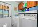 Functional laundry area with washer, dryer, storage cabinets, and a convenient exterior door at 7012 Walden Ct., Myrtle Beach, SC 29588