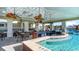 A luxurious poolside bar offers a relaxing space with ceiling fans, a swim-up counter, and comfortable seating areas at 7088 Shooting Star Way, Myrtle Beach, SC 29579