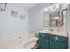 Relax in this well-lit bathroom that features a jetted tub with decorative cabinets at 712 Dogwood Dr. S # 101, Surfside Beach, SC 29575
