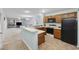 Open-concept kitchen with an eat-in bar, black appliances and views of living room at 712 Dogwood Dr. S # 101, Surfside Beach, SC 29575