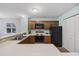 Kitchen featuring wood cabinets, black appliances, lots of counterspace, and an eat-in bar at 712 Dogwood Dr. S # 101, Surfside Beach, SC 29575