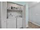 A convenient laundry room with a washer, dryer, and storage space at 712 Dogwood Dr. S # 101, Surfside Beach, SC 29575