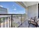 Balcony with seating overlooks a street and offers a distant ocean view at 7200 N Ocean Blvd. # 436, Myrtle Beach, SC 29572