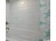 Clean bathroom showcasing the bathtub with white tile and a patterned shower curtain at 7200 N Ocean Blvd. # 436, Myrtle Beach, SC 29572
