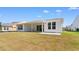 The backyard featuring a covered patio is ideal for outdoor entertaining and enjoying the fresh air at 1421 Crested Iris Way, North Myrtle Beach, SC 29582