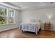 Cozy bedroom with hardwood floors, tray ceiling, and large window for natural light at 1421 Crested Iris Way, North Myrtle Beach, SC 29582