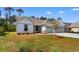 Charming one-story home with a well-manicured lawn and a three-car garage at 1421 Crested Iris Way, North Myrtle Beach, SC 29582
