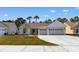 Beautiful home featuring a driveway, well-kept lawn, and a spacious three-car garage at 1421 Crested Iris Way, North Myrtle Beach, SC 29582