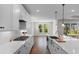A modern kitchen featuring white cabinets, stainless steel appliances, and a large island at 1421 Crested Iris Way, North Myrtle Beach, SC 29582