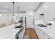 Spacious kitchen featuring a central island, stainless steel appliances, and hardwood floors at 1421 Crested Iris Way, North Myrtle Beach, SC 29582
