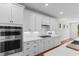 A kitchen showcasing sleek appliances, crisp white cabinetry, and ample counter space at 1421 Crested Iris Way, North Myrtle Beach, SC 29582