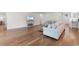 Bright living room featuring hardwood floors, a modern sofa, and an open floor plan at 1421 Crested Iris Way, North Myrtle Beach, SC 29582