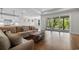 Inviting living room featuring a plush sofa, wood floors, and sliding glass doors to a patio at 1421 Crested Iris Way, North Myrtle Beach, SC 29582