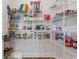 Organized pantry features metal shelving stocked with a variety of food and household items at 1421 Crested Iris Way, North Myrtle Beach, SC 29582