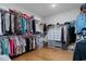 Large walk-in closet featuring custom shelving, hanging rods, and wood flooring at 1421 Crested Iris Way, North Myrtle Beach, SC 29582