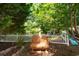 Secluded backyard retreat with a cozy bench overlooking a tranquil pond, framed by lush greenery at 761 Drawbridge Dr., Conway, SC 29526