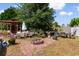Inviting backyard with a brick fire pit, multiple seating areas, and lush greenery at 761 Drawbridge Dr., Conway, SC 29526