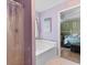 Bright bathroom with a soaking tub, complemented by calming lilac walls and natural light at 761 Drawbridge Dr., Conway, SC 29526