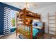 This bedroom offers wood bunk beds, ceiling fan, and a large window with plenty of sunlight at 761 Drawbridge Dr., Conway, SC 29526