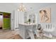 Kitchen island features white cabinets, modern lighting fixture, and seating at 761 Drawbridge Dr., Conway, SC 29526