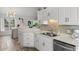 A gorgeous kitchen with white countertops, stainless steel sink, and modern lighting at 761 Drawbridge Dr., Conway, SC 29526
