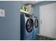 Modern laundry room with blue washer and dryer set and sleek black and white floors at 761 Drawbridge Dr., Conway, SC 29526