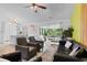 Bright living room with white brick accent wall, modern furniture, and light wood flooring at 761 Drawbridge Dr., Conway, SC 29526