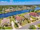 Aerial view of a neighborhood on a large lake showcasing waterfront homes, lush landscaping, and community amenities at 8050 Wacobee Dr., Myrtle Beach, SC 29579
