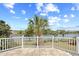 Scenic balcony view of a tranquil lake, enhanced by a palm tree and lush landscaping at 8050 Wacobee Dr., Myrtle Beach, SC 29579