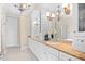Main bathroom with dual sinks, large mirrors, and decorative lighting at 8050 Wacobee Dr., Myrtle Beach, SC 29579