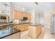 Well-lit kitchen featuring custom cabinets, a kitchen island, and granite countertops at 8050 Wacobee Dr., Myrtle Beach, SC 29579